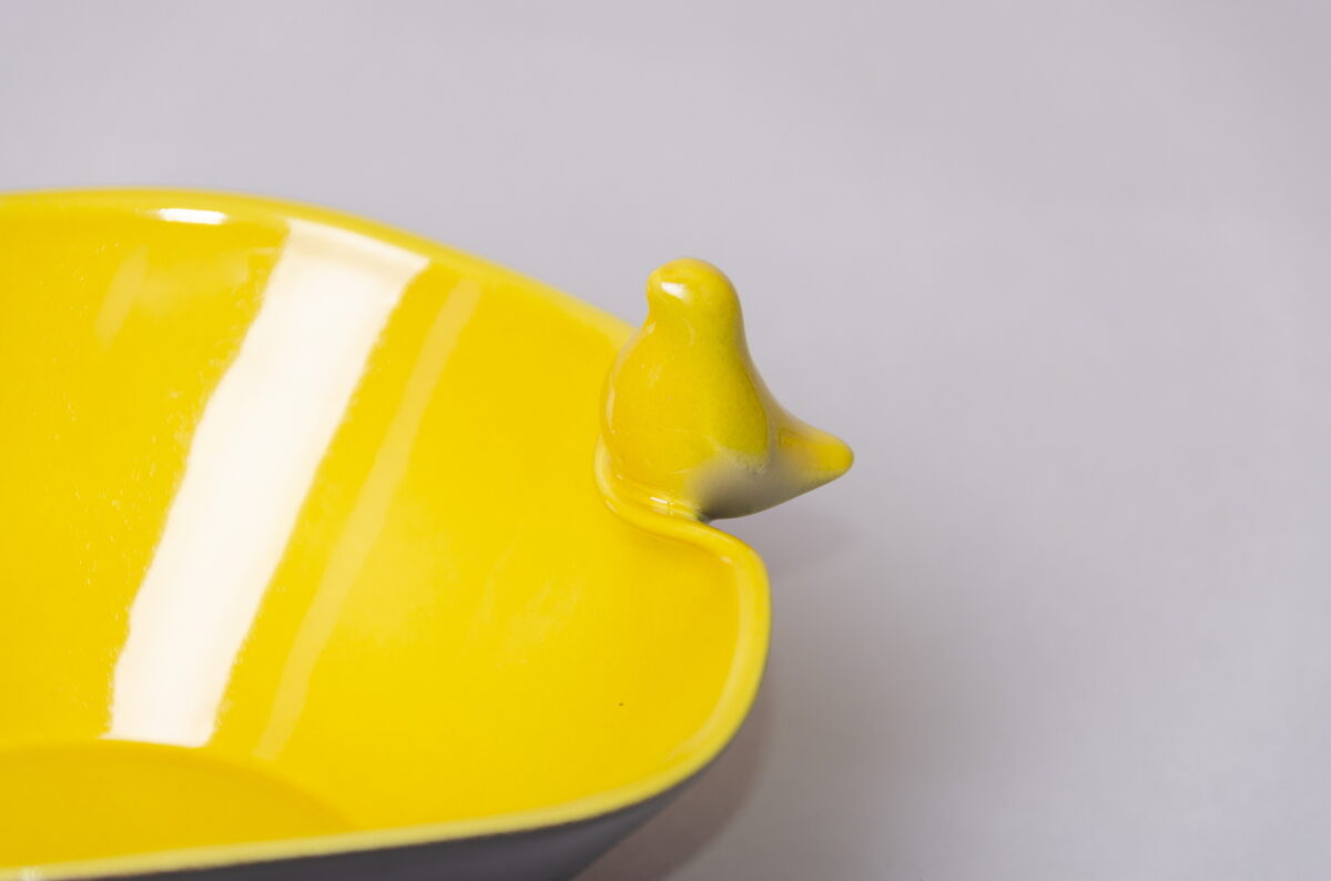 Ceramic snack bowl with bird figurine, lemon yellow